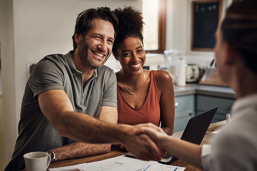 A couple smiling after getting help from MEMBERS Financial Services Program.