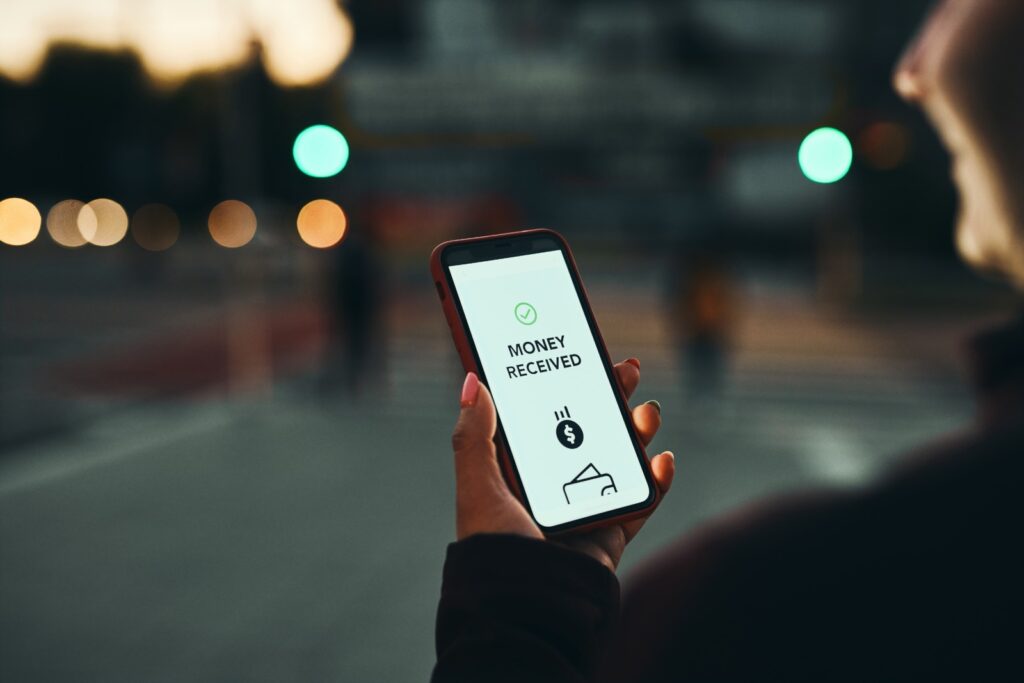 Person transferring money online using the Freedom CU mobile app, which conveniently allows you to send and receive money on your smartphone.