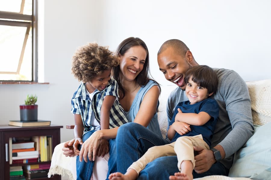 Happy family sitting on their couch