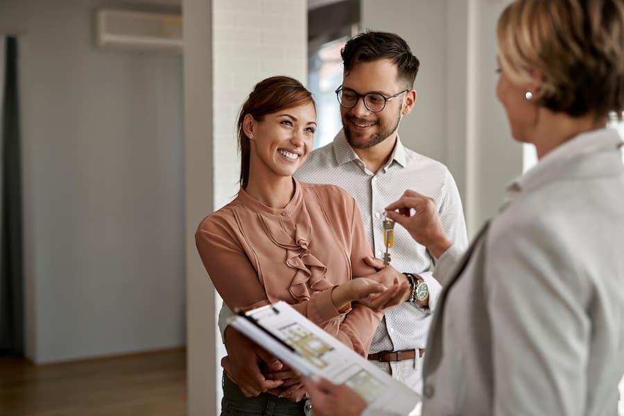 Young couple receiving the keys to their first home