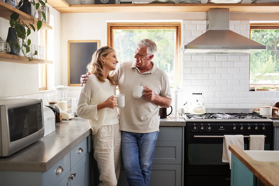 Couple standing in their kitchen together